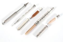 Five late 19th - early 20th century silver and white metal propelling pencils.