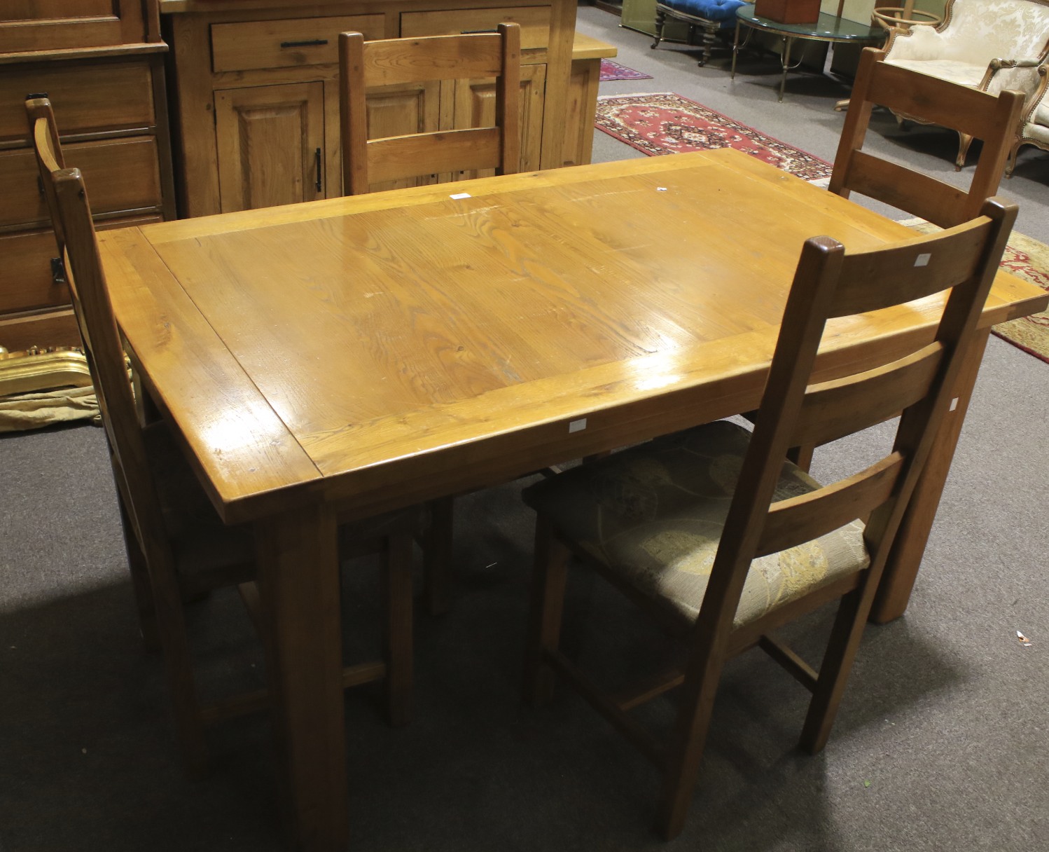 A contemporary dining table and four upholstered chairs.