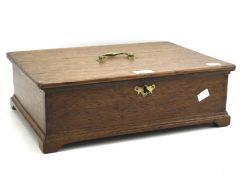 An oak documents box. With hinged lid and handle, lock and key, on bracket supports.