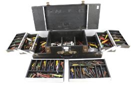 A cantilever fishing tackle box containing a large quantity of wooden,