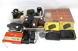 A collection of cameras and photographic accessories.