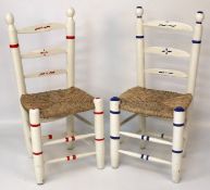 Two rush seated chairs painted in white with red and blue stripes.