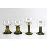 Four German green stemmed hock glasses.