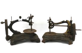 Two early cast metal sewing machines.