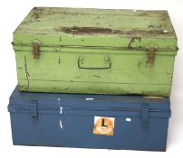 Two large metal travel trunks.