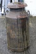 A black enamelled milk churn and lid marked TRUFOOD Ltd.