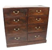 A 19th century mahogany chest of four dummy drawer cupboard flanked by four short drawers.