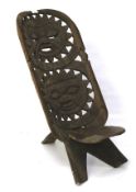 An unusual African carved wooden birthing chair.