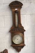 An early 20th century stained wooden wall barometer.