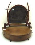 A 19th century oval swing mirror.