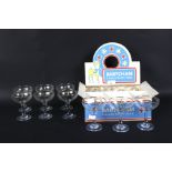 A boxed set of six vintage circa 1970s Babycham glasses and another set of six