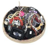 An extensive collection of mixed costume jewellery in a woven basket