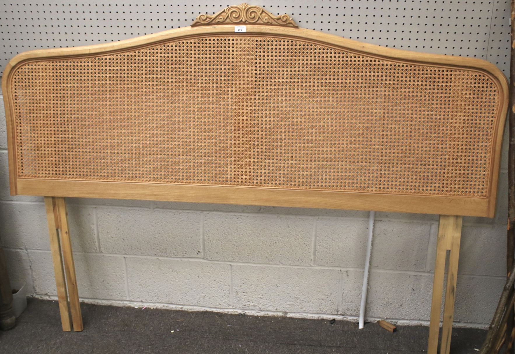 A king size rattan headboard with scroll finial