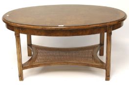 An oval walnut veneer coffee table.