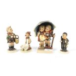 An assortment of four Hummel Goebel figures of children. Largest H15.