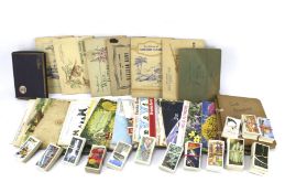 A collection of assorted cigarette cards.