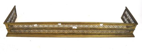 A Victorian brass fire fender, with pierced decoration,