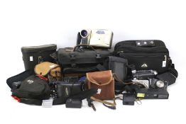 An assortment of vintage and modern cameras, video cameras and accessories.