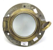 A vintage metal porthole cover.