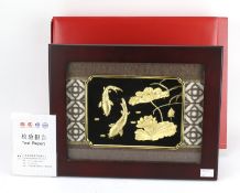 A Chinese gold plated three dimensional image of carp and water lilies.