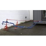 A blue and red painted plough marked BRENTON.
