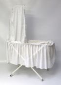 A late 19th/early 20th century white painted metal and macrame framed crib,