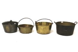 An assortment of vintage brass jam pans