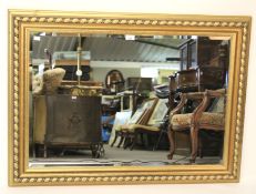 A modern gilt framed bevelled edge mirror.