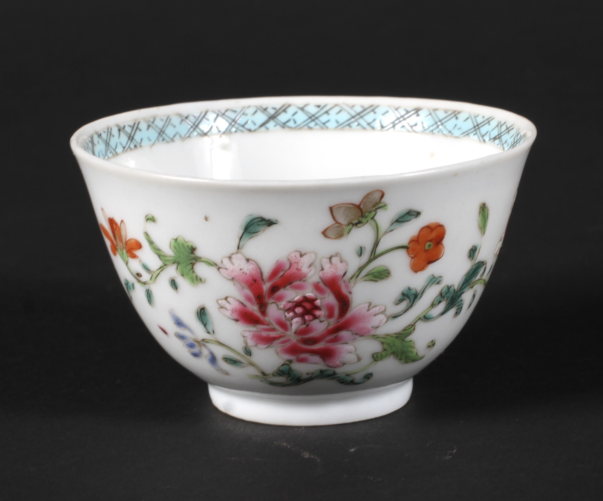 A Chinese famille rose tea bowl decorated with peonies.