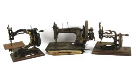 Three 19th century sewing machines.