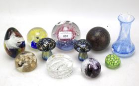 A collection of glass paperweights of various sizes and patterns.