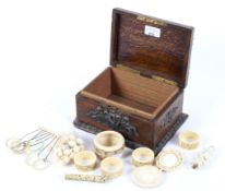 A fine oak box containing a quantity of 19th century ivory items.