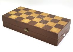 A boxed white and red stained bone chess set.