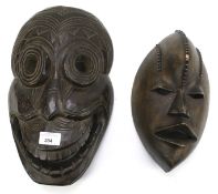 Two carved wooden tribal masks.