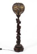 A carved wood and gilt-metal floor lamp, late 19th/early 20th century.