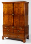 An 18th cetury Walnut linen press with shaped cornice above four sectioned venneered doors (no