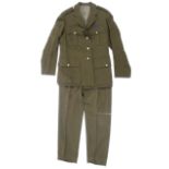 A 20th century British military army coat with related buttons and badges.