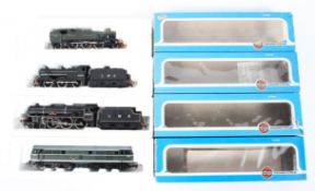A mixed collection of OO gauge locomotives and tenders.