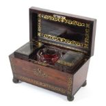 A Regency rosewood and brass inlaid sarcophagus shaped tea caddy.