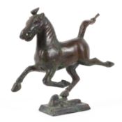 A Chinese archaic-style bronze model of a horse.