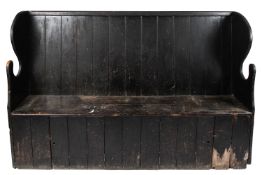 A 19th century ebonised oak settle. With plank back and seat above two cupboard doors, L213.