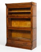 An oak glazed three tier bookcase in the style of Wernicke Globe, early 20th century.