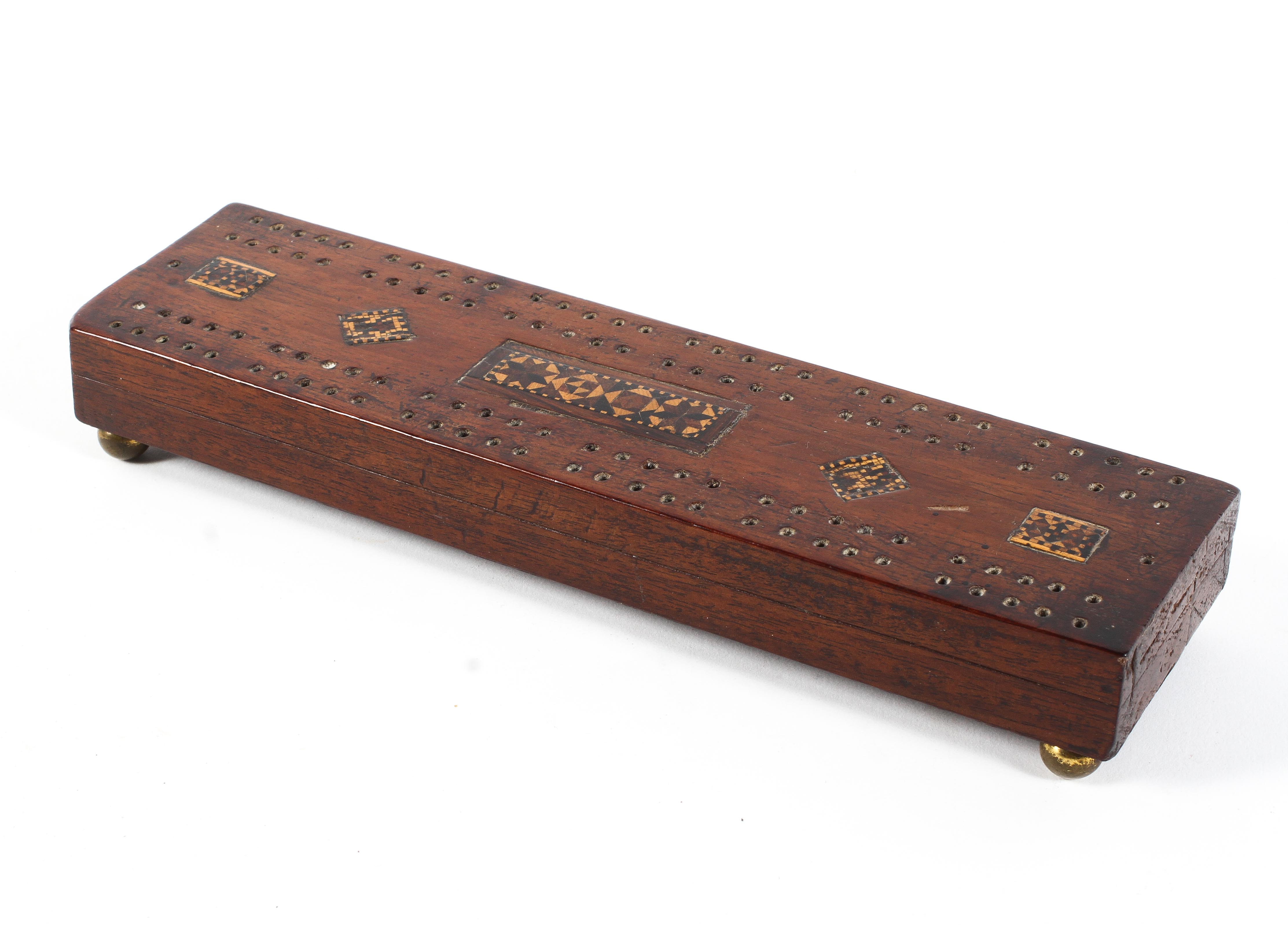 A 19th century mahogany cribbage board.