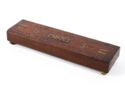 A 19th century mahogany cribbage board.
