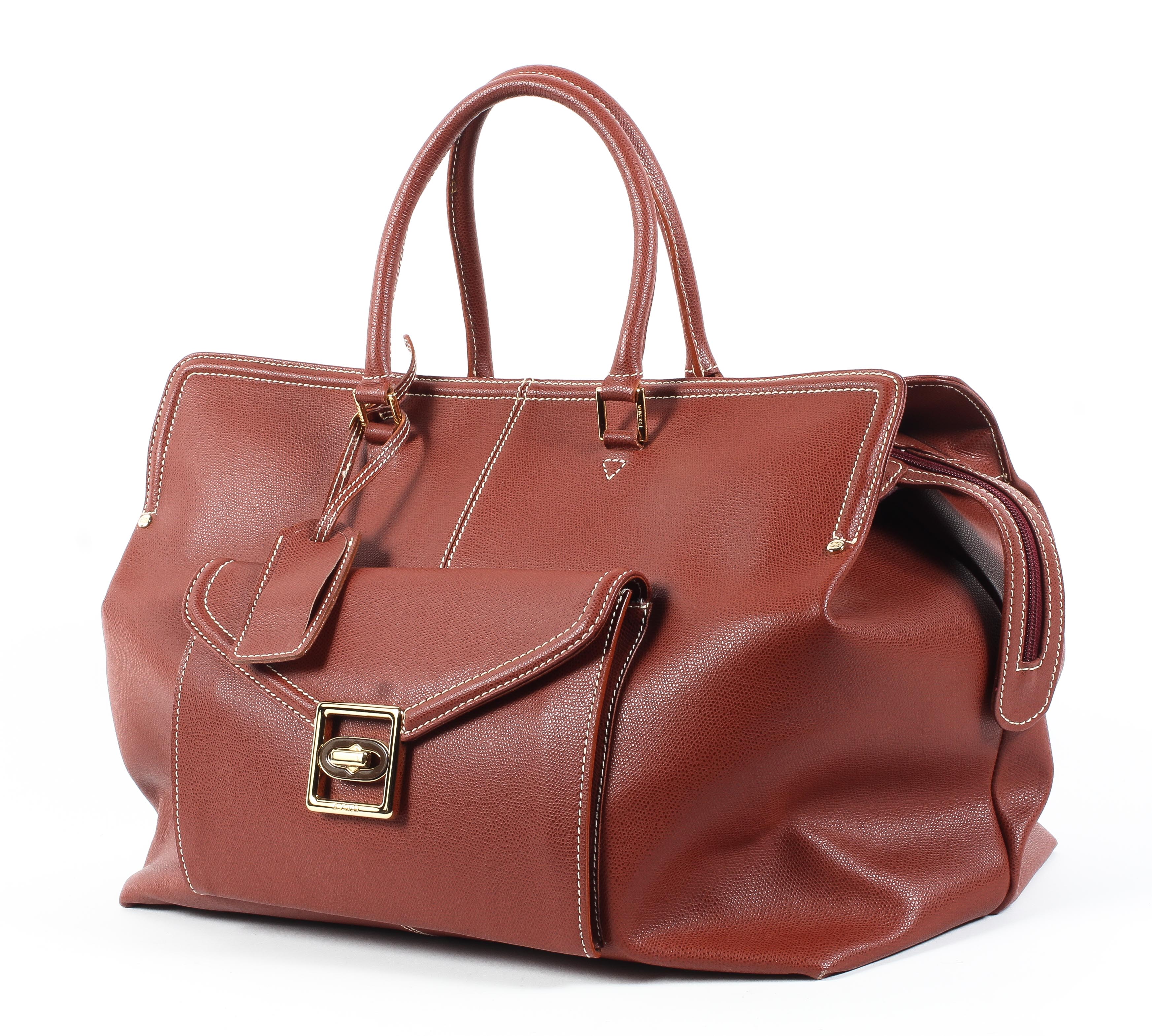 An Escade burgundy leather travel bag and dust bag Condition Report: Overall in good