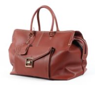 An Escade burgundy leather travel bag and dust bag Condition Report: Overall in good