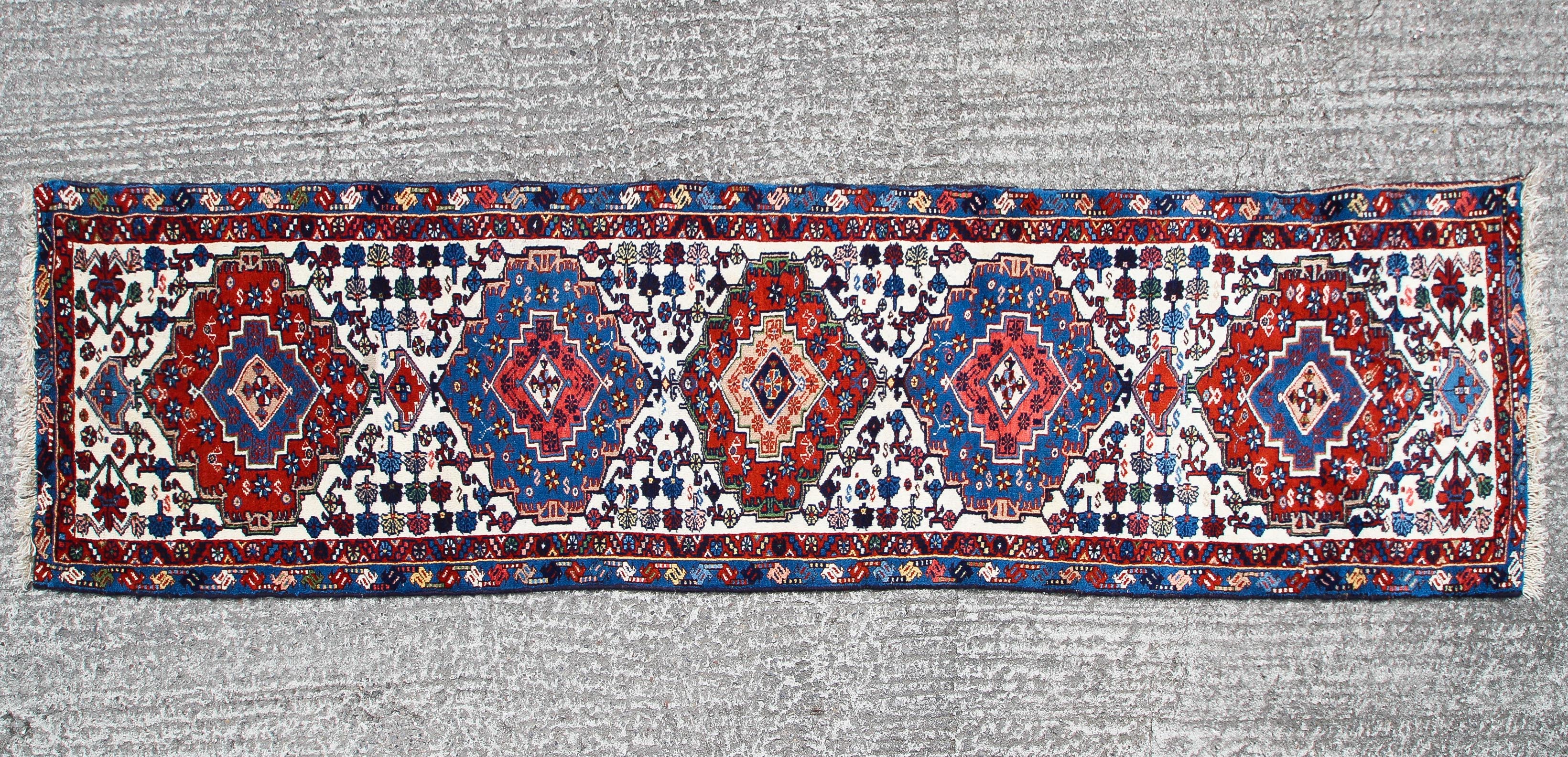 A Tabriz small runner with blue and red medallion on red blue cream ground 352x80cm
