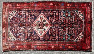 A Quality Hamedan rug with central cream medallion of Persian design in a border of blue red design.