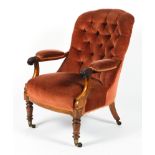 A Victorian upholstered button back arm chair.
