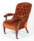 A Victorian upholstered button back arm chair.